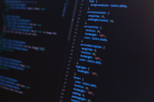 Close-up software developer programming code on screen
