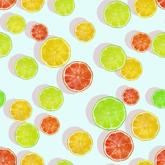 Seamless pattern with lemon, lime and grapefruit slices. Fruit background. Creative design for wrapping paper, printing on fabrics, clothing, products.
