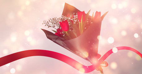 Bouquet with red flowers, tulips. Abstract bokeh light. Festive banner with flowers.