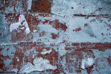 Texture of an old paint covered brick wall. Background image of an abandoned brick wall with...