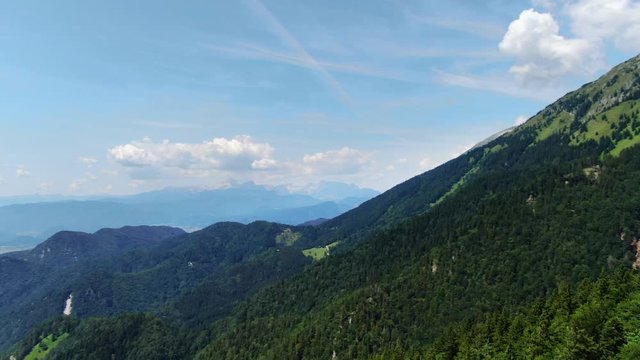 Aerial pan right above forest high on mountain prevala, slovenia