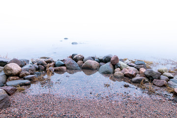 Sea view. foggy morning. stone coast