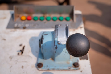 Controlling handle of pumping drive accelerator which is using for operate the pumping unit in drilling (oil field) industry. Close-up and selective focus photo.