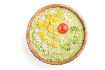 Green broccoli cream soup in wooden bowl isolated on white background. top view.