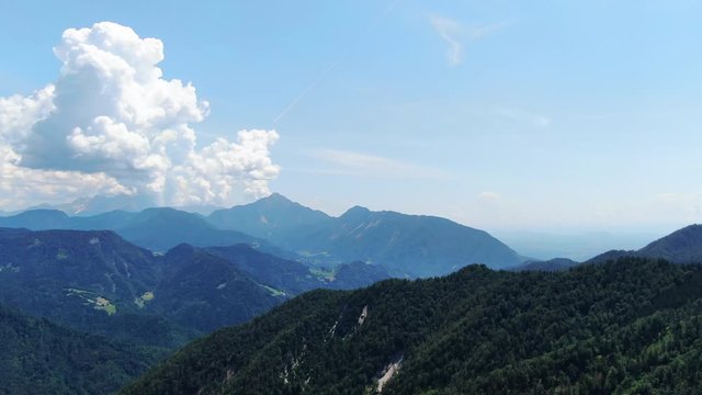Aerial view with epic clouds and forests on mount Prevala, slovenia
