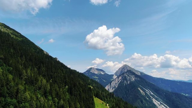 Aerial view of pine forest and mountain peaks high on mountain Prevala