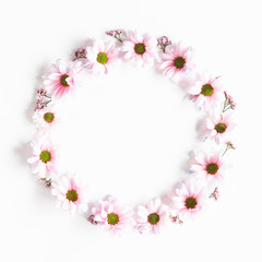 Flowers composition. Wreath made of pink flowers on white background. Flat lay, top view