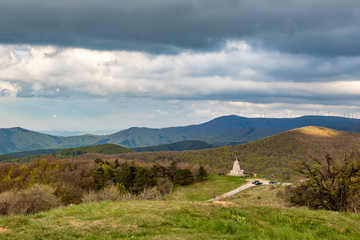 Dramatic autumn colorful view over mountain range from near Shipka peak, Stara Planina mountain in Central Bulgaria as seen from Shipka Memorial. Moody feeling. Old Russian cannons and memorial cross