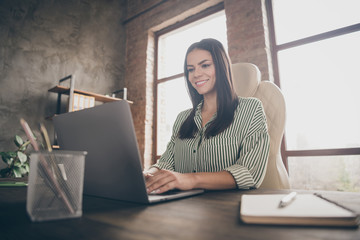 Fototapeta premium Portrait of her she nice attractive cheerful cheery businesslady writing e-mail creating 3d design presentation report data analysis at modern industrial brick loft interior style work place station