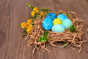 Spring Easter colorful painted eggs on the wooden background flat lay closeup top view beautiful picture. Congratulations card happy holiday