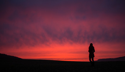 Girl on vacation watching a beautiful sunset