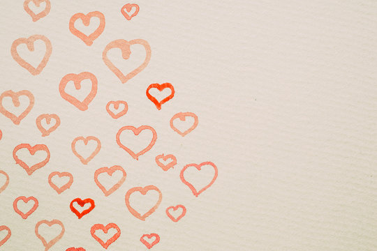 Hand painted hearts in red watercolors as background. Red watercolor hearts with copy space.