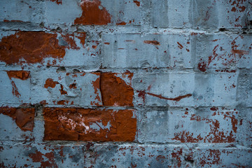 Texture of an old paint covered brick wall. Background image of an abandoned brick wall with painted over paint