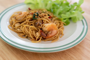 close up Spaghetti shrimp and vegetables on a wooden table