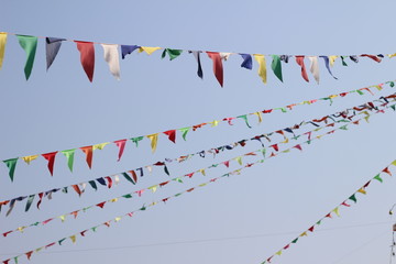 colorful triangle party flags on sky background for decoration