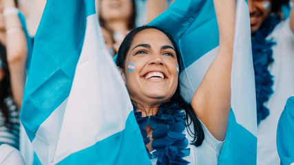 Argentinian football supporters cheering from stadium - obrazy, fototapety, plakaty