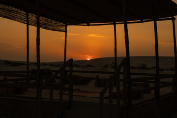 View of beautiful sunset at Desert Safari Camel Ride, a landmark for desert activities, in Al Wakrah, Qatar.