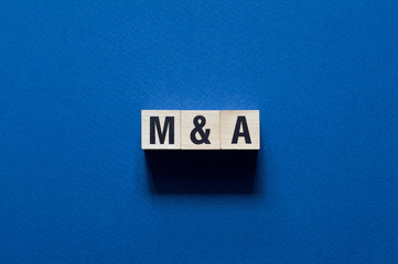 Mergers & Acquisitions word concept on cubes
