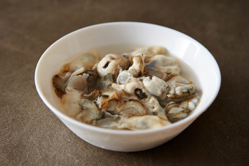 Fresh oysters in white bowl 