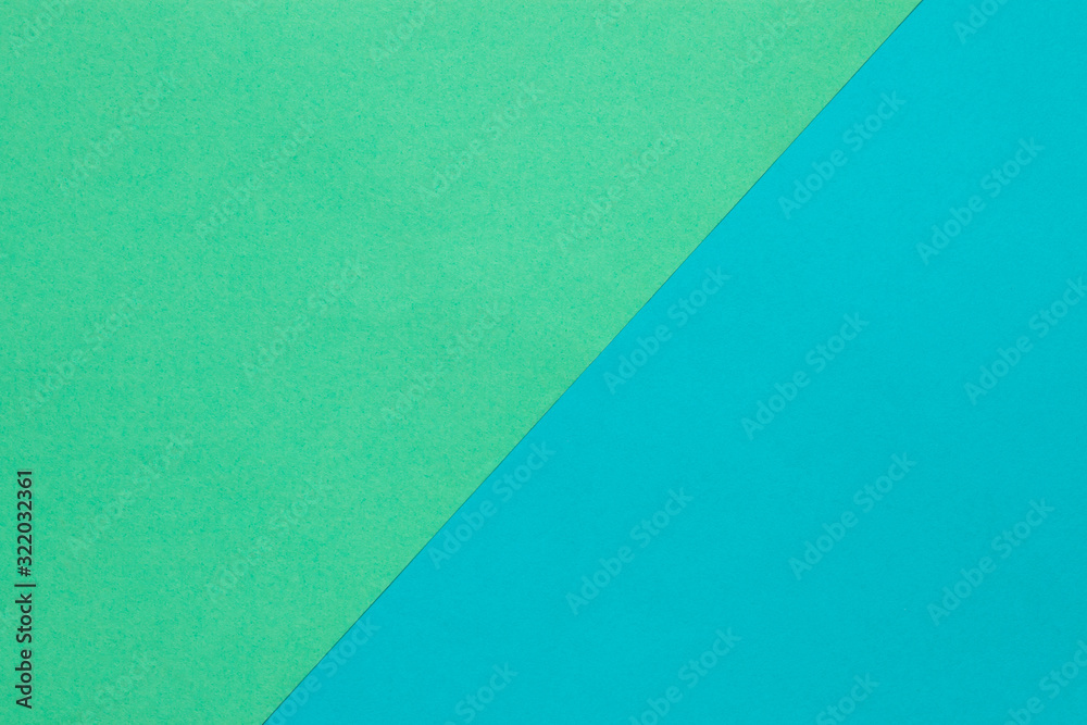 Wall mural background of two sheets of colored paper, green and blue.