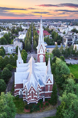 Aerial view of the church at sunset in Joensuu, Finland. On the background city streets.