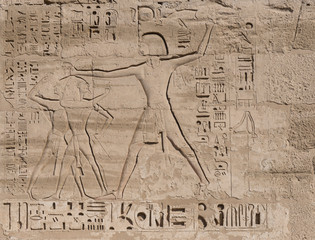 Hieroglyphic carvings on an ancient egyptian temple wall