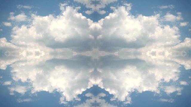 Creative 4k time lapse video of moving clouds with reflection and mirror effect as in a kaleidoscope. Beautiful mirrored pattern of fast moving clouds in a blue summer sky.