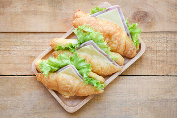 croissant sandwiches on wooden table , top view - croissant salad ham vegetable