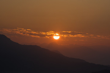 Beautiful Sunrise and Beautiful sunset between the mountain with orange sky, Blue sky 