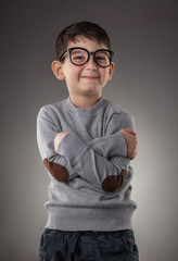 cute smiling boy in glasses on gray background. Studio portret © Dmytro Titov