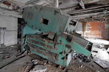 Fototapeta na wymiar Broken industrial malt equipment at an abandoned brewery