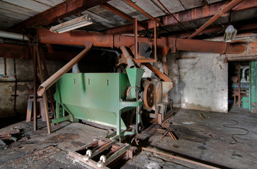 Fototapeta na wymiar Broken malt equipment at an abandoned brewery