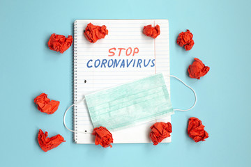 Stop coronavirus text written on open notebook