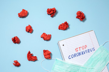 Stop coronavirus text written on open notebook