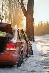 car and ice on the winter road. The car had an accident in the winter, crashed into a tree and slid...
