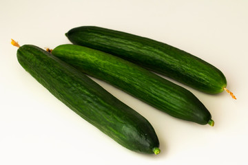 long-fruited smooth cucumbers on a white background