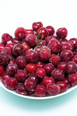 group of frozen cherries on a white background . close-up of berries. ice crystals on the fruit. vertical photo top view