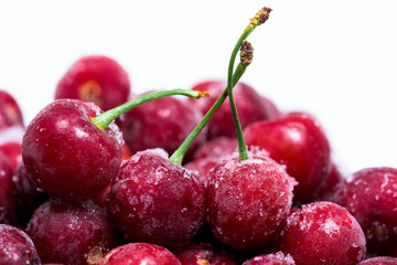 group of frozen cherries on a white background . close-up of berries. ice crystals on the fruit