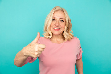 Portrait of happy mid woman showing lie sign