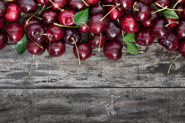 Red cherry on a old wooden background, top view ith copy space