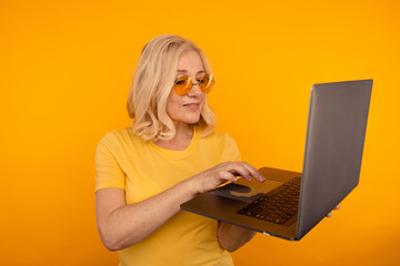 Midage woman with laptop isolated check her mail and typing