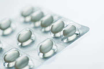 Tablets in a foil packaging on white