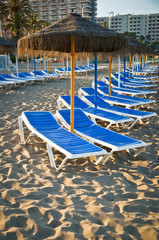 Sun loungers on a beach in Torremolinos, Malaga, Spain