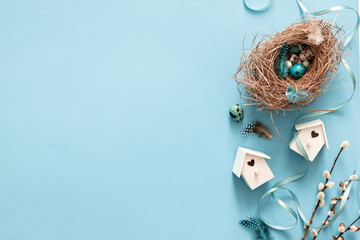 Easter quail eggs in bird nest on blue background, flat lay, copyspace. Easter holiday decorations , Easter concept background - Image