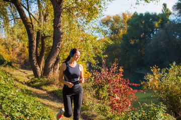 Fototapeta premium Woman jogging and listening to music with wireless headphones