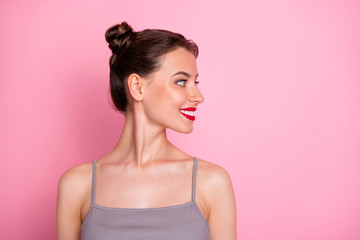 Closeup profile photo of pretty amazing young lady funny buns red pomade looking empty space wear casual summer grey tank-top isolated pastel pink color background