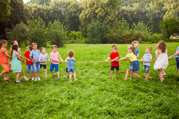 Obraz premium Group of kids are playing tug of war