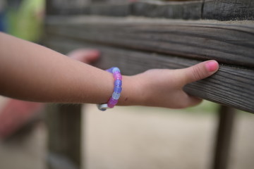 Fototapeta premium A kid's hands holding on to a bench