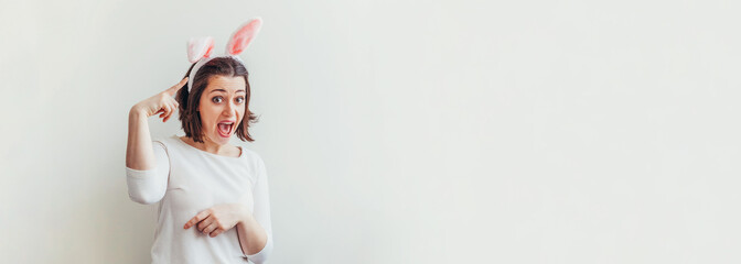 Happy Easter holiday celebration spring concept. Young woman wearing bunny ears isolated on white background. Preparation for holiday. Girl looking happy and excited, having fun on Easter day. Banner