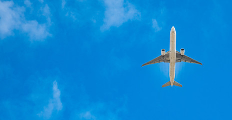 modern passenger plane on blue sky, copy space